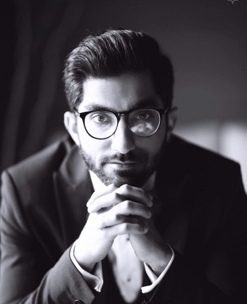 Umair Jarral sitting with hands under chin
