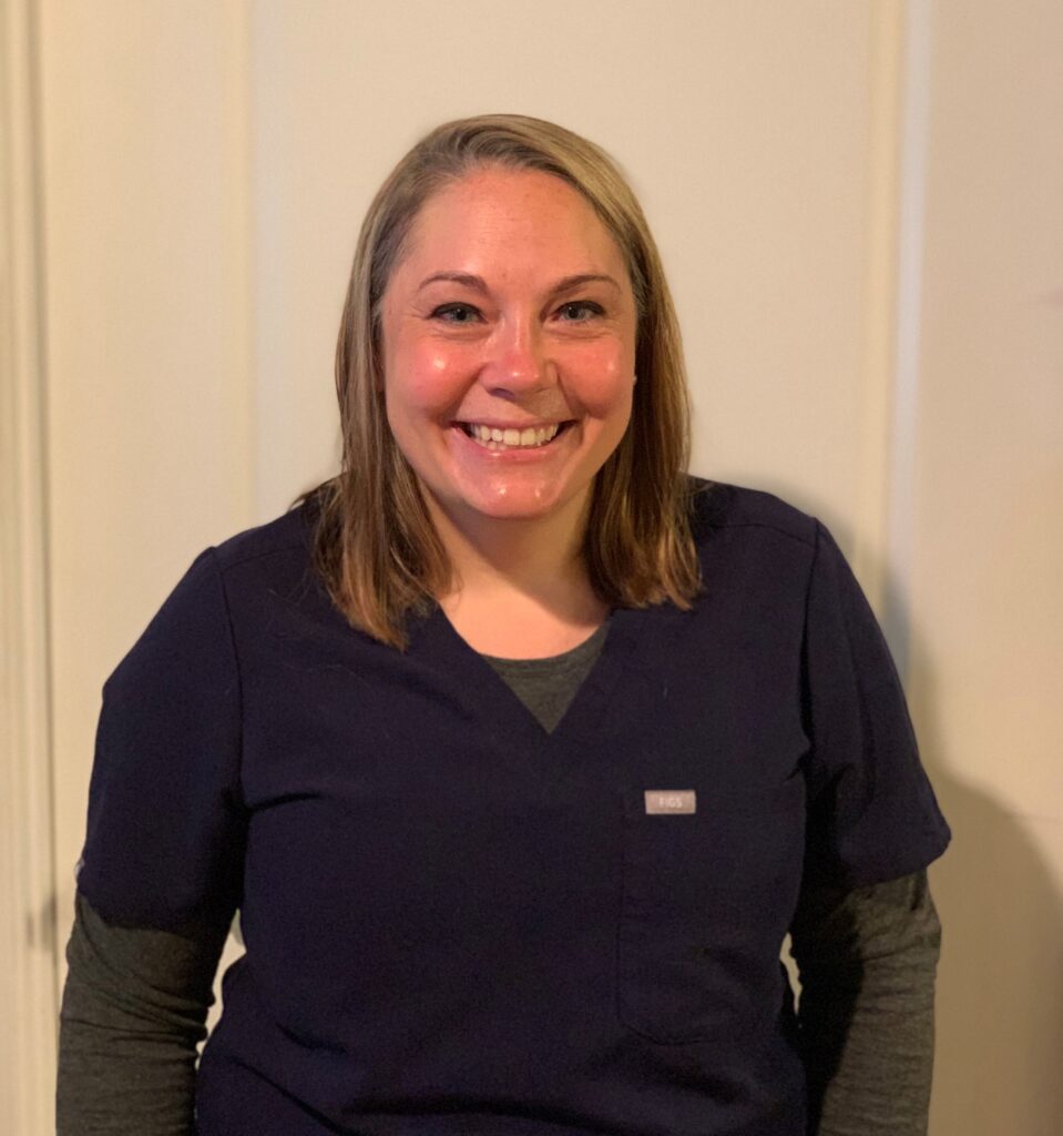 Woman in scrubs smiling