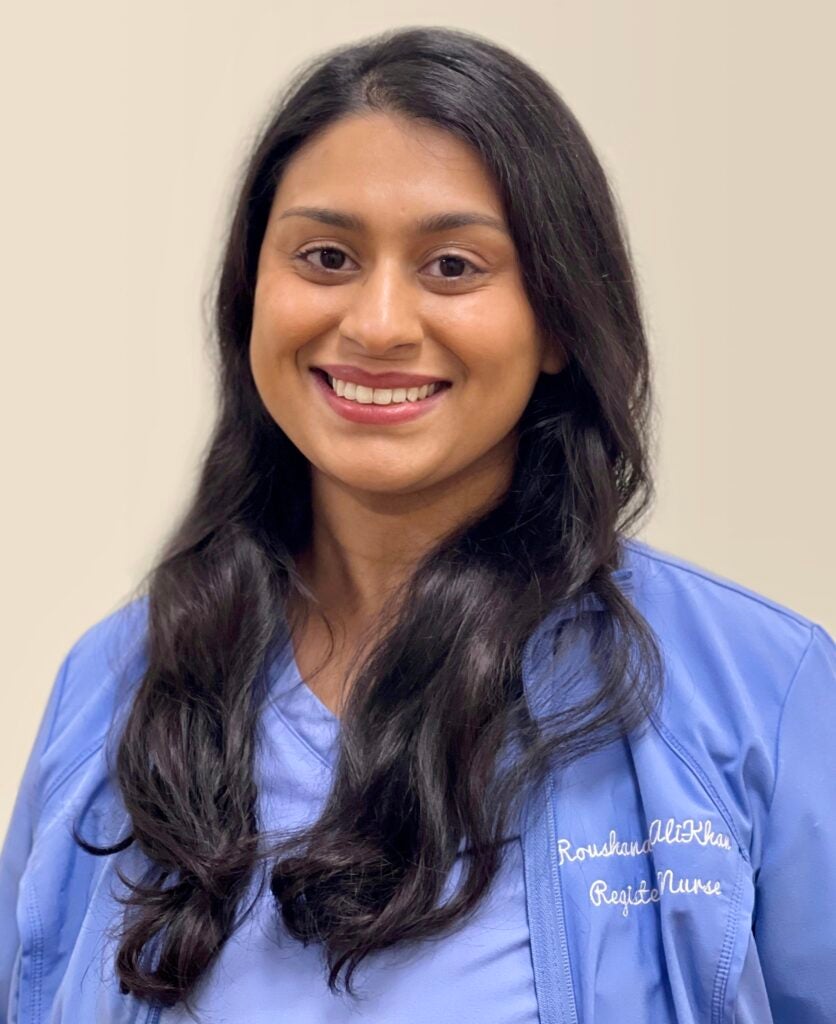 Woman smiling wearing scrubs