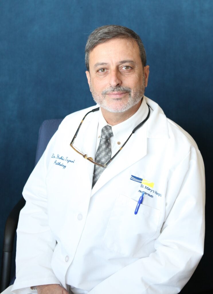 doctor in white coat looking at camera